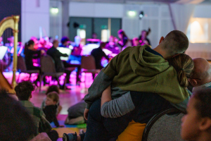 A family sharing a hug at one of our performances