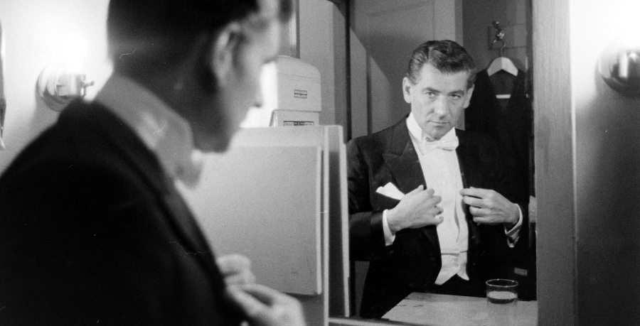 Bernstein in a tuxedo looking at himself in the mirror