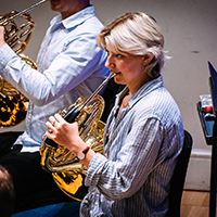 Zoe Tweed playing the horn in rehearsal at Cadogan Hall